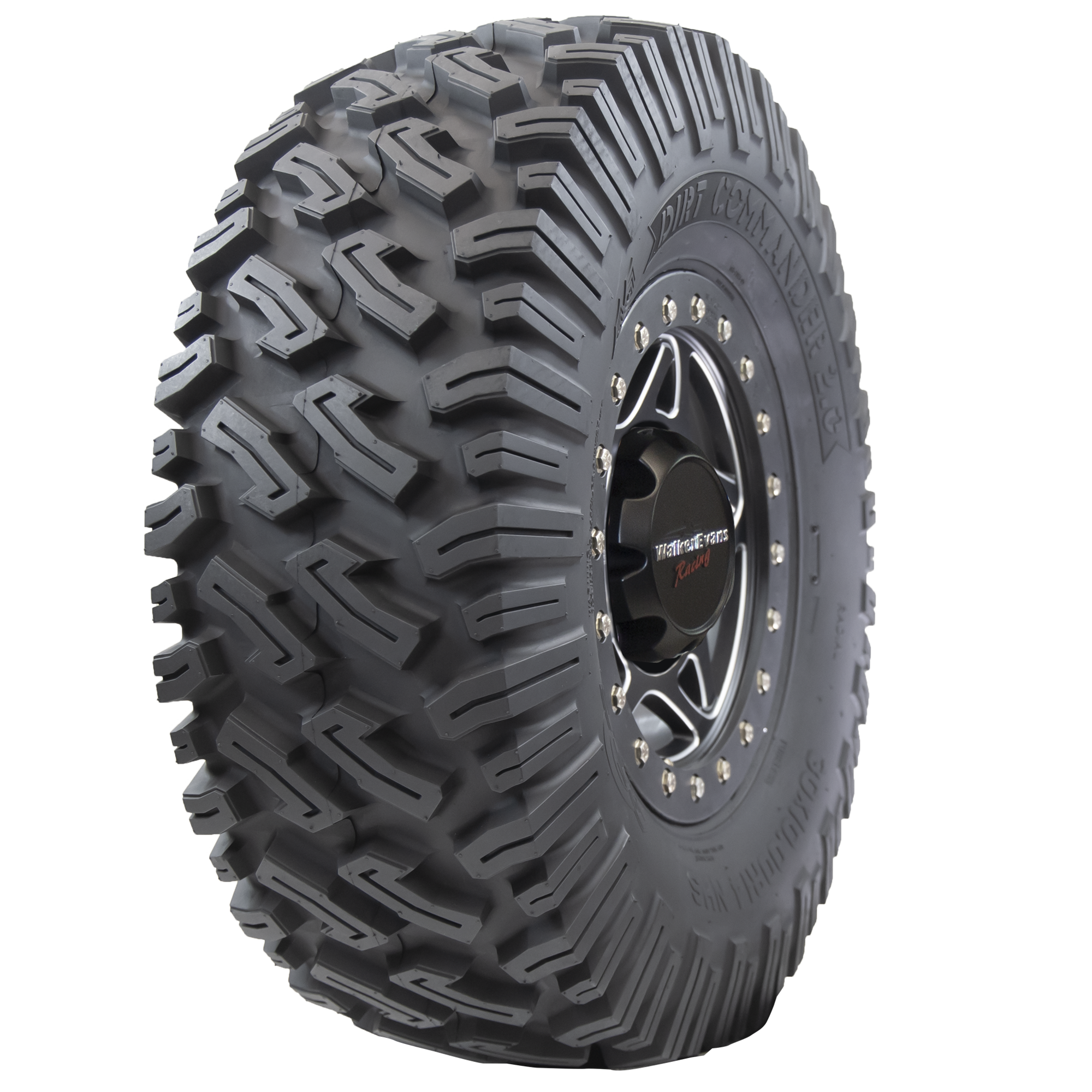 Angle view of Dirt Commander 2.0 ATV/UTV tire, showing off the tread, a section of the sidewall, and the rim. The tire features a sturdy square shoulder profile for maintaining grip and bite, ensuring optimal performance even at extreme speeds and during sharp cornering.