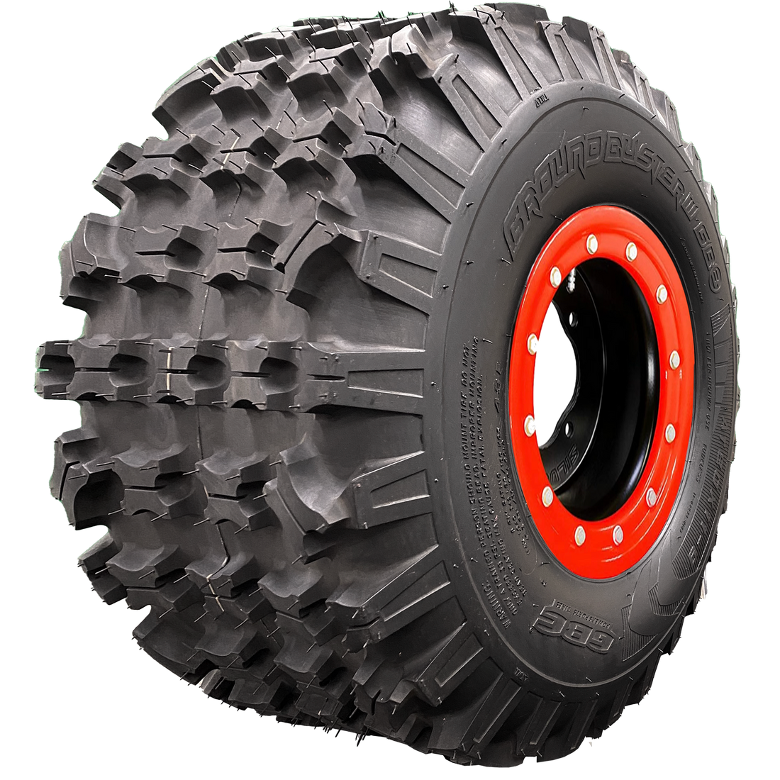 Angle view of Ground Buster 3 ATV tire, exhibiting the tread, a section of the sidewall, and the rim. This image reveals the tire's non-directional sipped X-knob tread pattern for maximum flexibility. The hefty sidewall lugs ensure optimum cornering traction and control, perfect for intermediate to hard terrain racing.