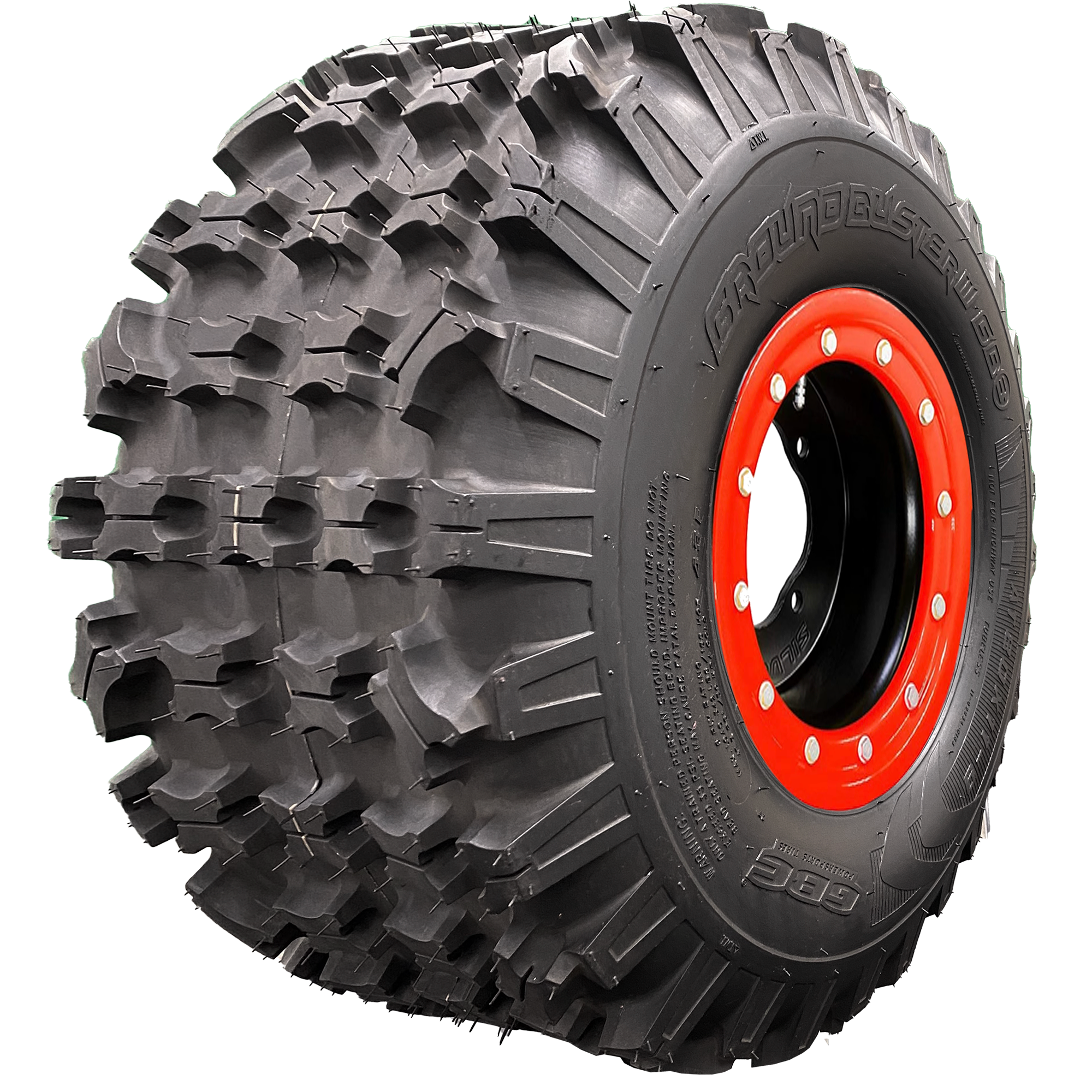 Angle view of Ground Buster 3 ATV tire, exhibiting the tread, a section of the sidewall, and the rim. This image reveals the tire's non-directional sipped X-knob tread pattern for maximum flexibility. The hefty sidewall lugs ensure optimum cornering traction and control, perfect for intermediate to hard terrain racing.