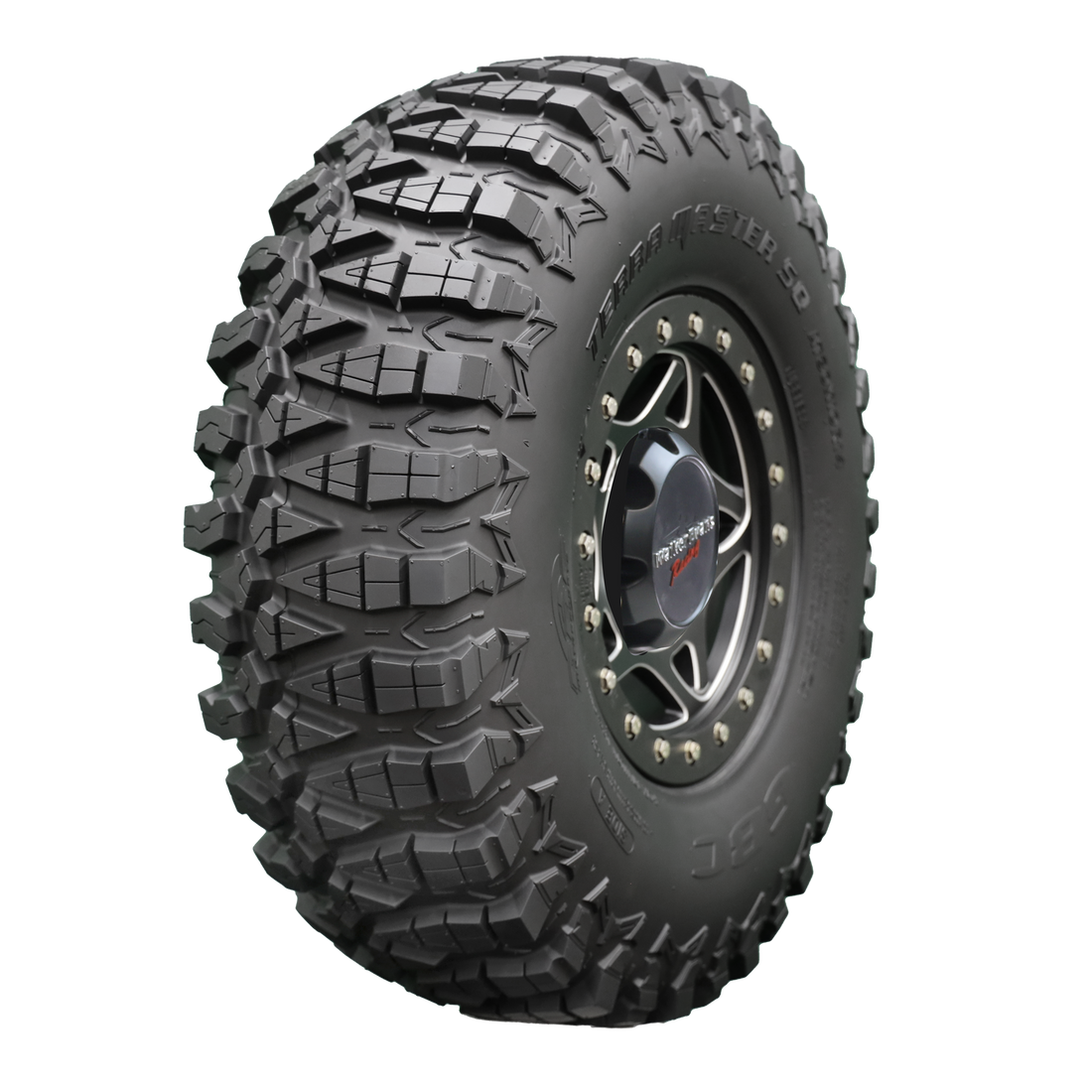 Angle view of Terra Master SQ UTV tire, showcasing the tread, a section of the sidewall, and the rim. The image emphasizes the tire's advanced square shoulder design for a bold new profile, offering a distinct look compared to the original Terra Master. Its side bite design promises greater control during cornering